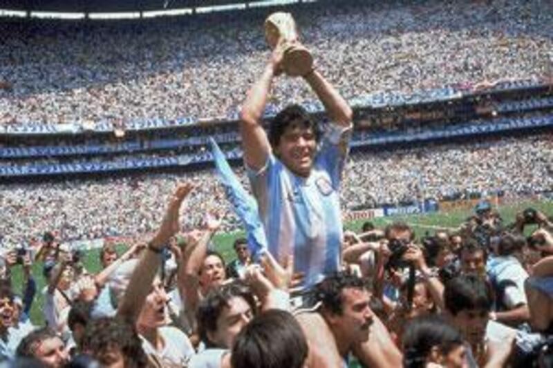 Argentina's Diego Maradona holds up the World Cup Trophy after his side defeated West Germany in the 1986 World Cup final.