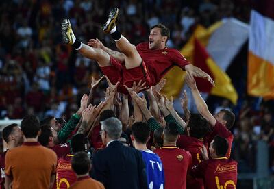 (FILES) This file photo taken on May 28, 2017 shows AS Roma players celebrate Roma's captain Francesco Totti during a ceremony following his last match with AS Roma after the Italian Serie A football match AS Roma vs Genoa at the Olympic Stadium in Rome. 
Roma legend Francesco Totti confirmed his retirement on July 17, 2017 and will take a directorship role at the Serie A club. / AFP PHOTO / Vincenzo PINTO