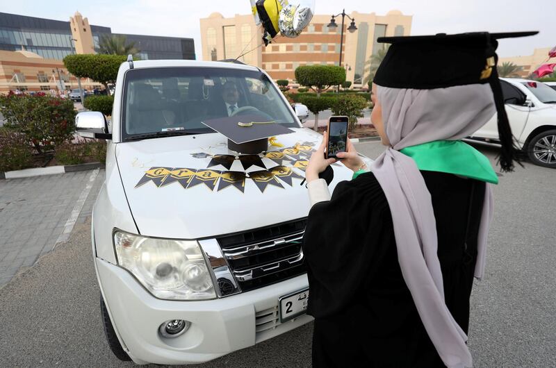 Ajman, United Arab Emirates - Reporter: Anam Rizvi. News. A student takes a picture of her car before her drive through graduation from Ajman University because of Covid-19. Wednesday, February 10th, 2021. Ajman. Chris Whiteoak / The National