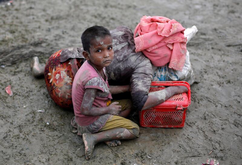 A Rohingya refugee and her mother resting after crossing the Bangladesh-Myanmar border in Teknaf in 2017.