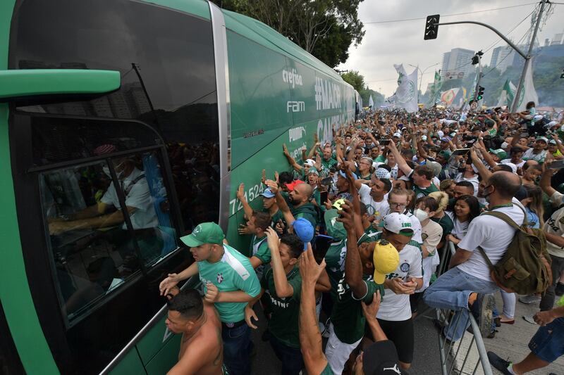 Supporters of Palmeiras surround a bus taking its players from the club's training centre to the airport, where they will fly to Abu Dhabi to play in the FIFA Club World Cup, in Sao Paulo, Brazil. AFP