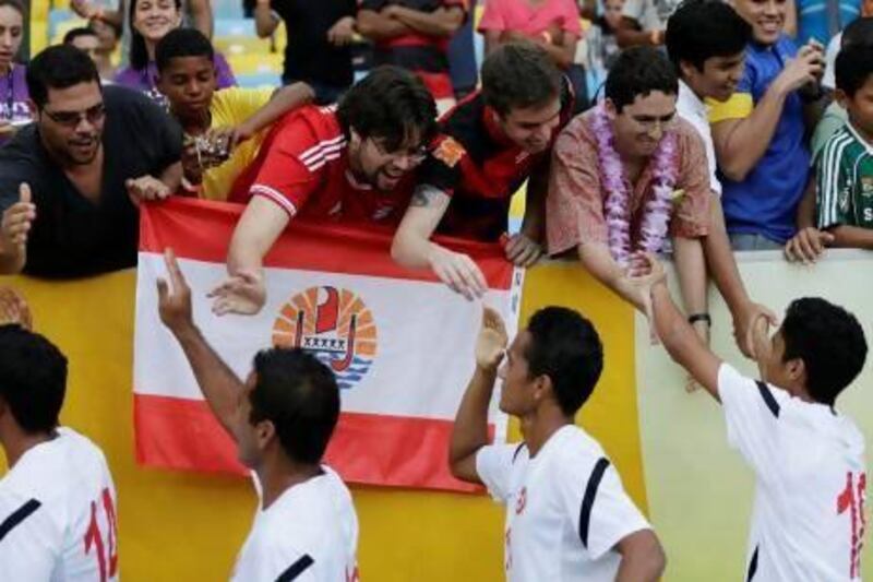 Tahiti players shake hands with fans at the Maracana in Rio de Janeiro before their Confederations Cup game with Spain.