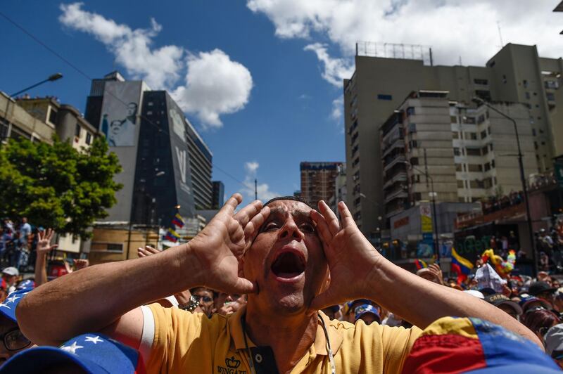 TOPSHOT - A supporter of Venezuelan opposition leader and self declared acting president Juan Guaido shouts during a rally to press the military to let in US humanitarian aid, in eastern Caracas on February 12, 2019.
 The tug of war between the government and opposition is centred on whether humanitarian aid will be allowed into the economically crippled country, which suffers shortages of food, medicine and other basics. / AFP / Federico PARRA
