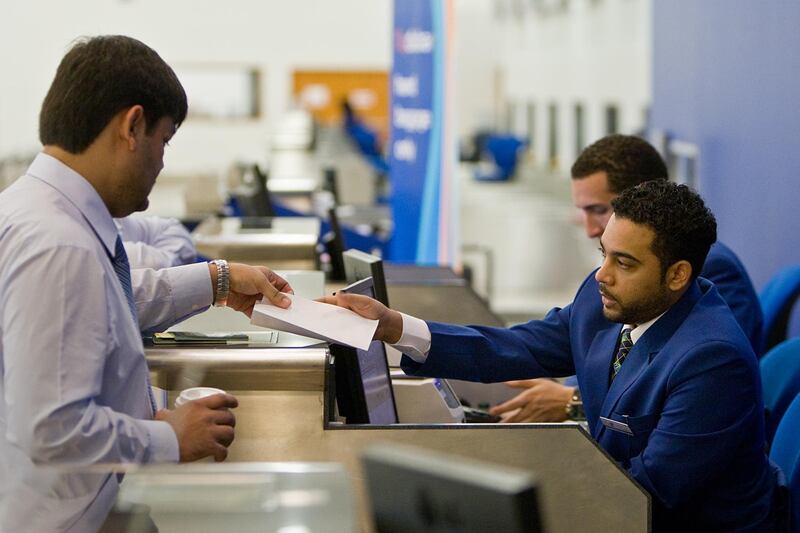 United Arab Emirates - Dubai - August 2, 2010.

BUSINESS: Fly Dubai passenger service agents print a customer a boarding pass at the ticket counter in Dubai International Airport Terminal 2 in Dubai on Monday, August 2, 2010. Amy Leang/The National