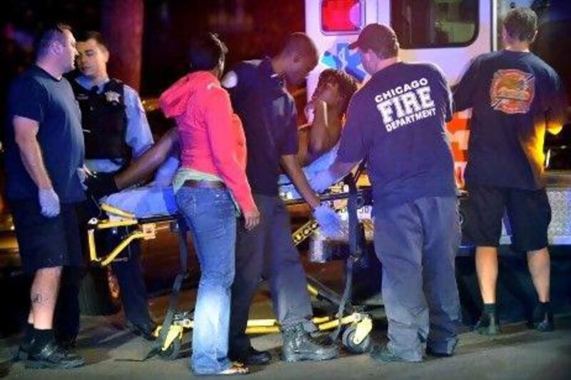 Police investigate the scene of a shooting on Chicago's south side.  The rate of murders in Chicago has increased 25 per cent over the same period last year.