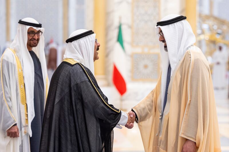 Sheikh Khaled bin Mohamed, Crown Prince of Abu Dhabi and Chairman of Abu Dhabi Executive Council, greets Sheikh Meshal, with Sheikh Mohamed looking on.
Ryan Carter / UAE Presidential Court
