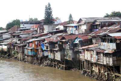 Houses along the banks of the Ciliwung River in Jakarta, Indonesia. The pandemic pushed about 70 million people into extreme poverty in 2020. EPA