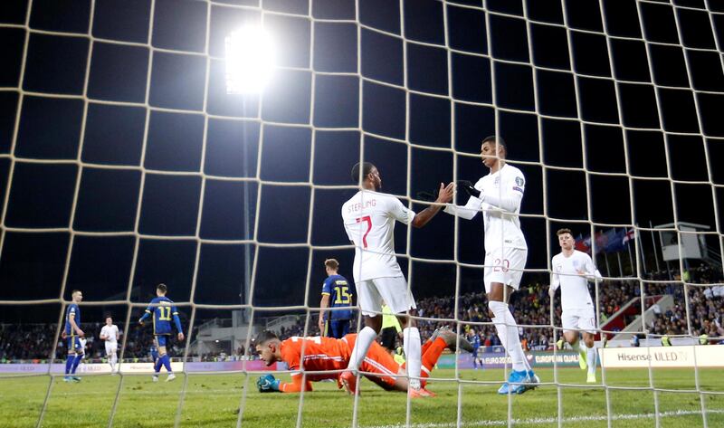 England's Marcus Rashford celebrates scoring their third goal with Raheem Sterling. Reuters