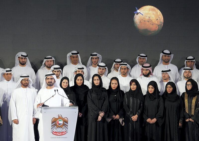 Sheikh Mohammed bin Rashid al-Maktoum, Prime Minister of the United Arab Emirates (UAE) and ruler of Dubai speaks among engineers and scientists during a ceremony to unveil UAE's Mars Mission on May 6, 2015 in Dubai. The UAE Mars Mission aims to provide a global picture of the Martian atmosphere through a probe named Al Amal to be launched in July 2020 to reach Mars in 2021, according to the engineers involved in the project.  AFP PHOTO / KARIM SAHIB (Photo by KARIM SAHIB / AFP)