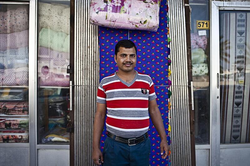 Ganesh Pandey, a salesman of a mobile accessories shop near the Msheirab Neighbourhood construction site. The working-class community of largely South Asian and Filipino men still carries the quaint if somewhat gritty charm of other melting-pot areas in the Gulf, such as Dubai’s Deira neighbourhood.