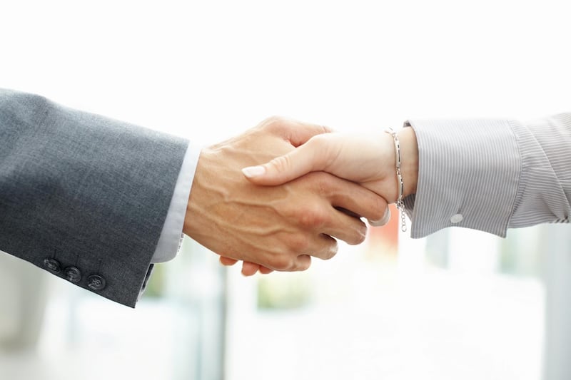 Cropped image of business man and woman shaking hands, side view