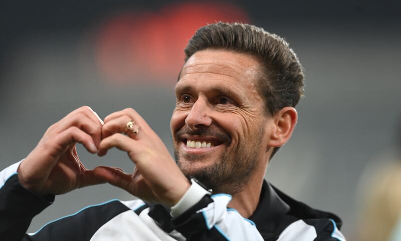 Newcastle coach Jason Tindall smiles and makes a heart shape with his hands. Getty Images