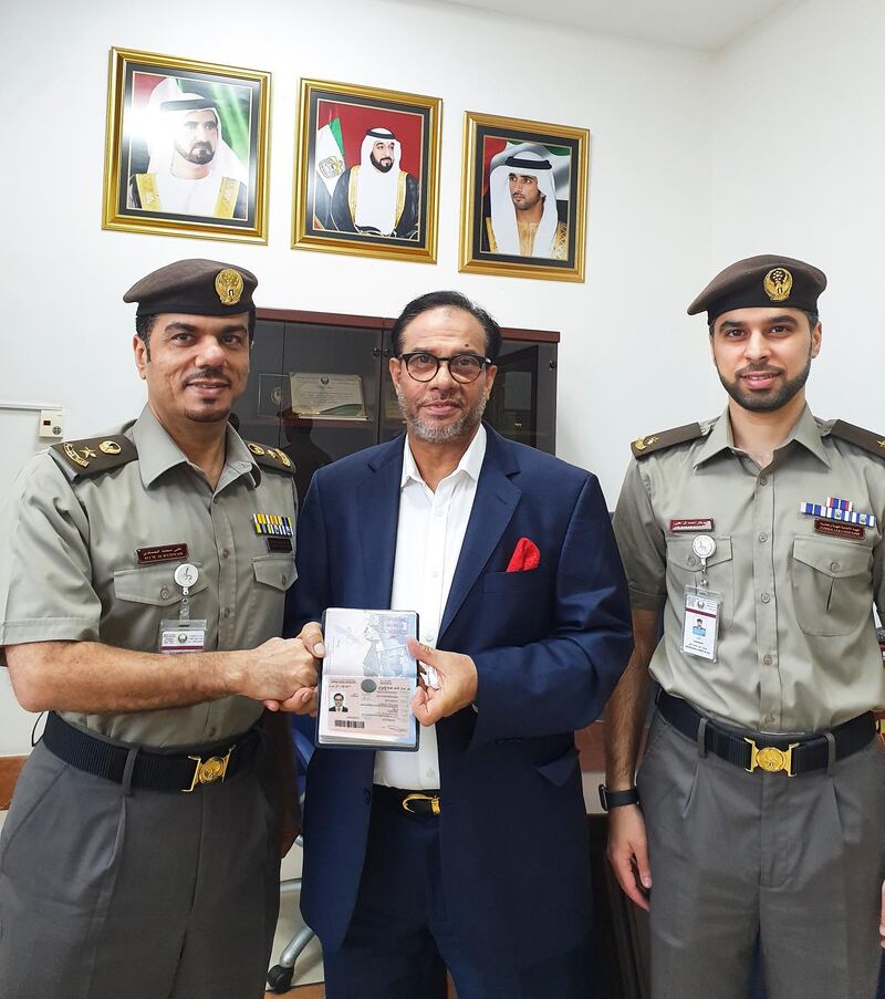 Fragrance tycoon Mohammed Rahman (C) receives his golden card visa at Dubai's immigration service, the General Directorate of Residency and Foreigners Affairs. The businessman, who runs Al Haramain Group, was the first Bangladeshi to receive the visa. Photo: GDRFA