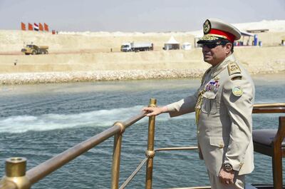 A handout picture provided by the Office of the Egyptian Presidency shows Egyptian President Abdel Fattah al-Sisi standing on an historic yacht leading a naval flotilla during a ceremony on August 6, 2015 to unveil a new waterway at the Suez Canal, in the port city of Ismailiya. AFP PHOTO / HO / EGYPTIAN PRESIDENCY / MOHAMED ABDELMOATY == RESTRICTED TO EDITORIAL USE MANDATORY CREDIT "AFP PHOTO / HO / EGYPTIAN PRESIDENCY / MOHAMED ABDELMOATY" - NO MARKETING NO ADVERTISING CAMPAIGNS - DISTRIBUTED AS A SERVICE TO CLIENTS == (Photo by MOHAMED ABDELMOATY / EGYPTIAN PRESIDENCY / AFP)