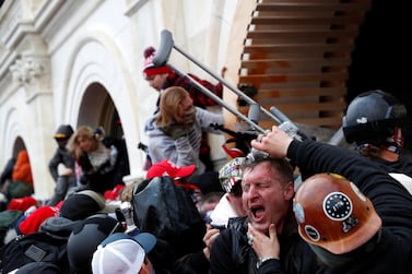 A protester is helped after getting tear gassed during a clash with Capitol police. Reuters