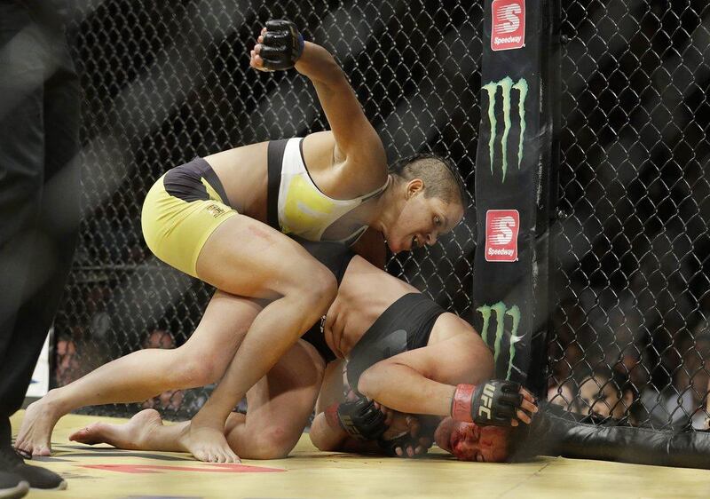 Amanda Nunes, left, fights Miesha Tate during their women's bantamweight bout at UFC 200, Saturday, July 9, 2016, in Las Vegas. John Locher / AP Photo