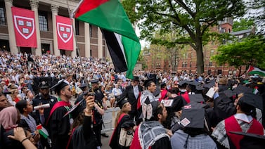 Graduates at Harvard University in Massachusetts hold Palestinian flags and chant as they walk out in support of students barred from graduating due to protest activities. AP