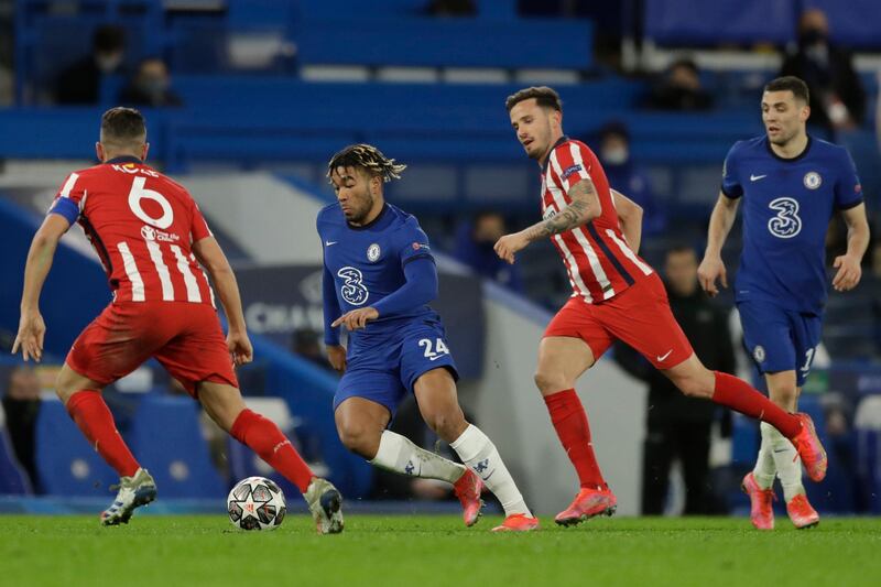 Chelsea's Reece James, second left, runs with the ball past Atletico Madrid's Koke, left, and Atletico Madrid's Saul during the Champions League, round of 16, second leg soccer match between Chelsea and Atletico Madrid at the Stamford Bridge stadium, London, Wednesday, March 17, 2021. (AP Photo/Matt Dunham)