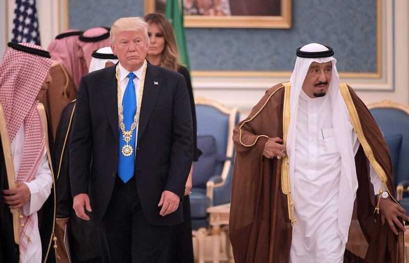 US President Donald Trump walks with Saudi Arabia's King Salman bin Abdulaziz al-Saud after receiving the Order of Abdulaziz al-Saud medal from at the Saudi Royal Court in Riyadh on May 20, 2017. (Photo by MANDEL NGAN / AFP)