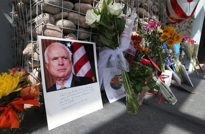 PHOENIX, AZ - AUGUST 26: Items and personal notes are left outside the office of Sen. John McCain (R-AZ) as people pay their respects to the late Arizona senator on August 26, 2018 in Phoenix, Arizona. McCain passed away on Saturday, August 25, 2018 after a long battle with Glioblastoma, a form of brain cancer.   Ralph Freso/Getty Images/AFP
== FOR NEWSPAPERS, INTERNET, TELCOS & TELEVISION USE ONLY ==
