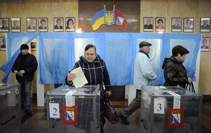 A woman casts her ballot at a polling station in Sevastopol during the Crimean referendum on March 16. Andrew Lubimov / AP Photo