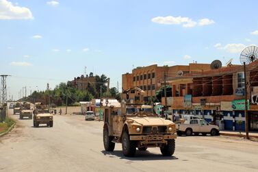 US military vehicles patrol the town of Rmelane in Syria's Hasakeh province on June 5, 2018. AFP  