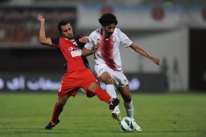 Zayed Al Kathiri of Al Wahda negotiates the ball against Al Shaab.