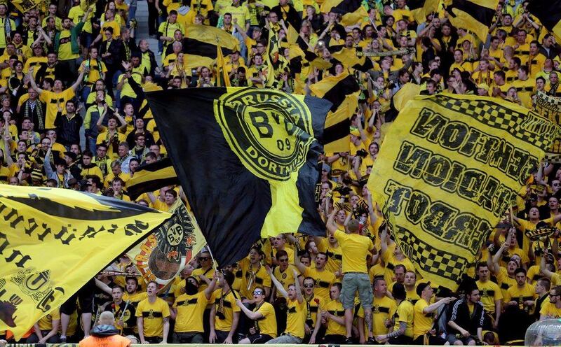 Borussia Dortmund fans cheer and wave flags before the German Cup final on Saturday. Kay Nietfeld / EPA / May 17, 2014