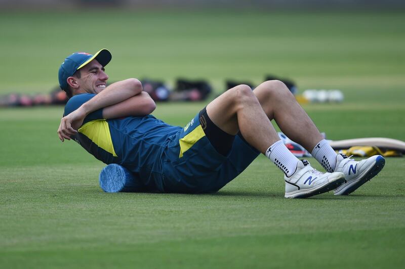 Australian cricketer Pat Cummins stretches his back during a training session at Wankhede Stadium in Mumbai on January 11, 2020, ahead of their three-match one day international series against India. (Photo by Indranil MUKHERJEE / AFP) / ----IMAGE RESTRICTED TO EDITORIAL USE - STRICTLY NO COMMERCIAL USE----- / GETTYOUT