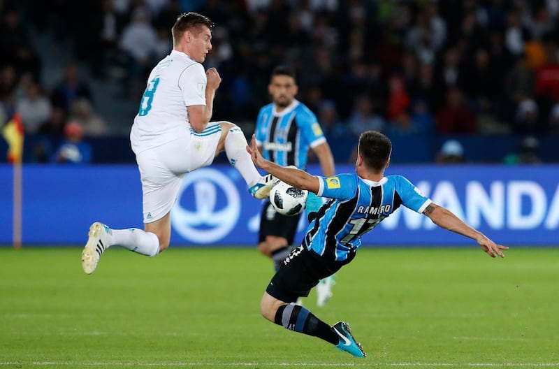 Real Madrid's Toni Kroos, left, goes for the ball with Gremio's Ramiro during the Club World Cup final soccer match between Real Madrid and Gremio at Zayed Sports City stadium in Abu Dhabi, United Arab Emirates, Saturday, Dec. 16, 2017. (AP Photo/Hassan Ammar)
