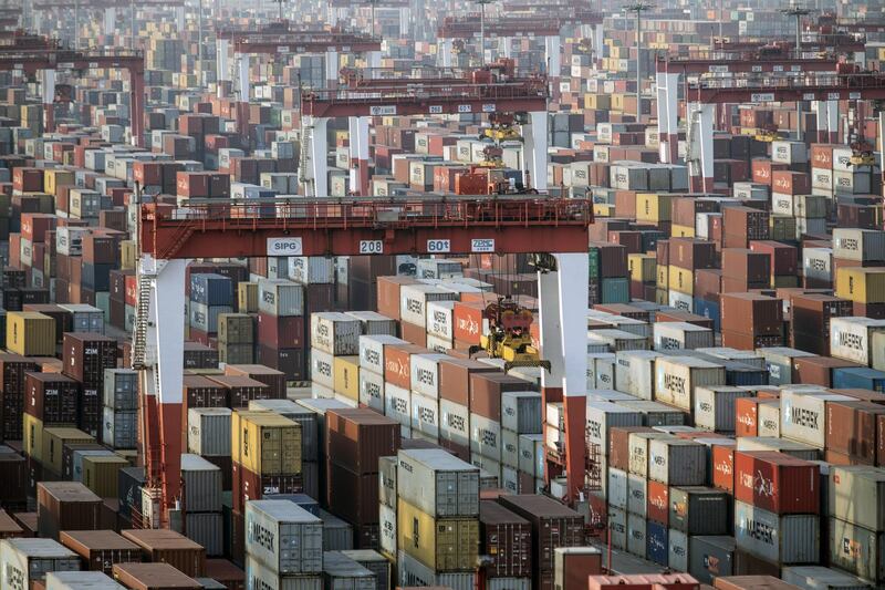 Shipping containers next to gantry cranes at the Yangshan Deepwater Port in Shanghai, China, on Monday, Jan, 11, 2021. U.S. President Donald Trump famously tweeted that "trade wars are good, and easy to win" in 2018 as he began to impose tariffs on about $360 billion of imports from China. Turns out he was wrong on both counts. Photographer: Qilai Shen/Bloomberg