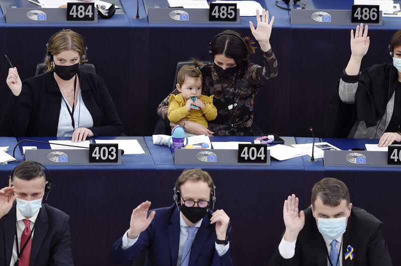 Member of the European Parliament Irena Joveva, with her daughter, takes part in a voting session in Strasbourg, France. AFP