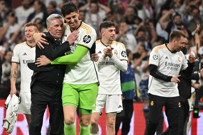 Real Madrid manager Carlo Ancelotti and goalkeeper Thibaut Courtois celebrate victory. AFP