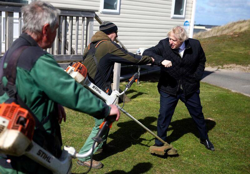 Britain's Prime Minister Boris Johnson meets with staff during a visit to Haven Perran Sands Holiday Park in Perranporth, Cornwall. AP Photo