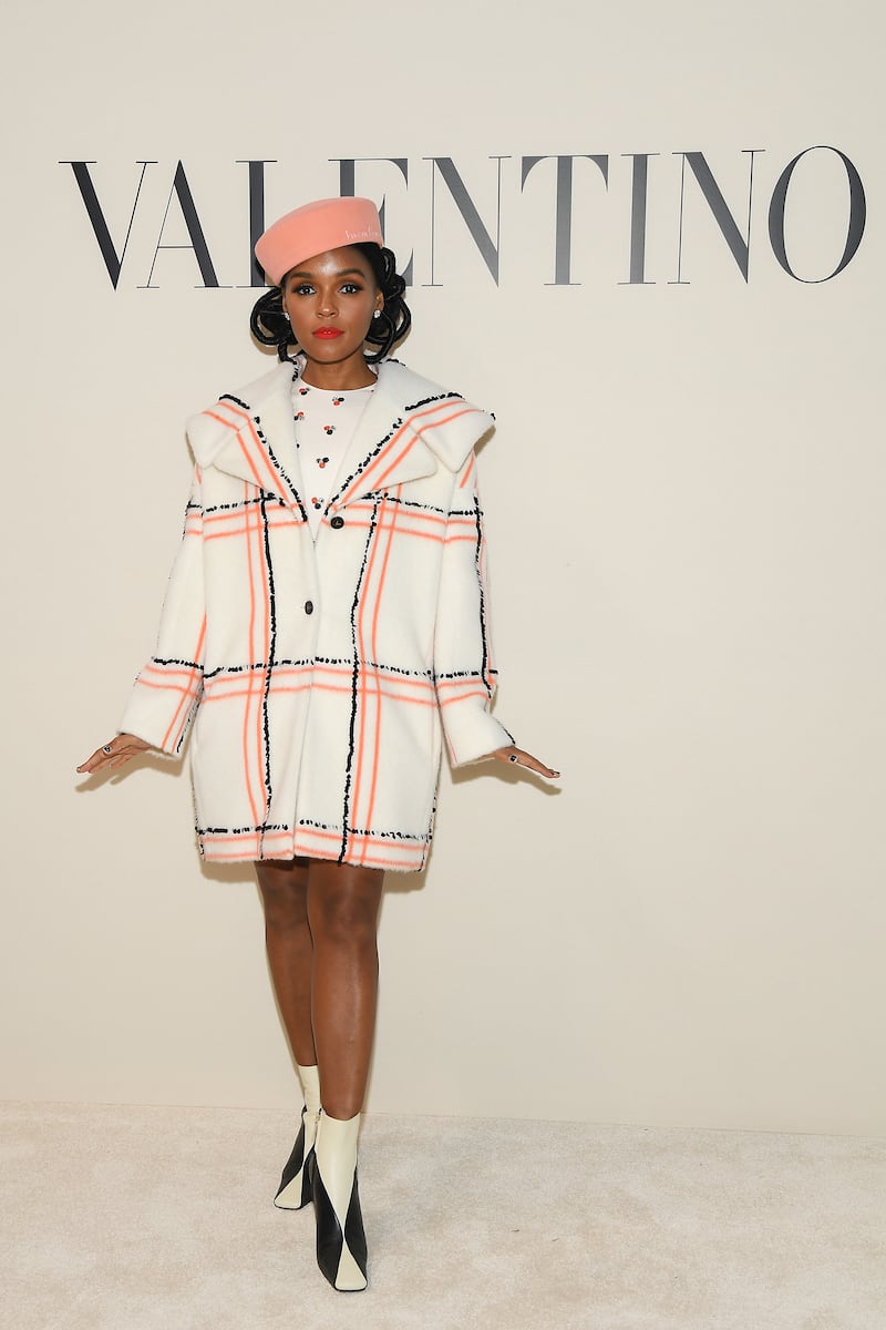Janelle Monae, wearing a white checked Valentino coat, attends the brand's Paris Fashion Week runway show on March 1, 2020. Getty Images