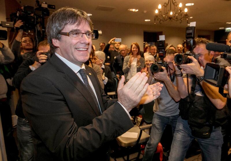 FILE - In this Saturday, Nov. 25, 2017 file photo, ousted Catalan president Carles Puigdemont attends a presentation of the candidate list for the Catalan regional elections in Oostkamp, Belgium. A Spanish judge on Tuesday Dec. 5, 2017, has withdrawn the European arrest warrants for ousted Catalan leader Carles Puigdemont and four members of his former cabinet who were fighting extradition from Belgium. (AP Photo/Olivier Matthys, File)