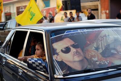 FILE PHOTO: An image of Syria's President Bashar al-Assad is seen on a car's windscreen as Hezbollah supporters celebrate, after the Syrian army took control of Qusair from rebel fighters, in the Shi'ite town of Hermel June 5, 2013. Syrian government forces and their Lebanese Hezbollah allies seized control of the border town of Qusair on Wednesday, dealing a major defeat to rebel fighters battling to overthrow Assad. REUTERS/Jamal Saidi/ File Photo