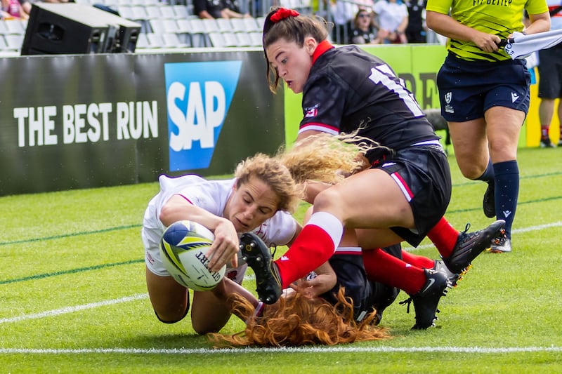 Winger Abby Dow, left, of England scores a try during the Women's Rugby World Cup Semi Final match between Canada and England at Eden Park in Auckland, New Zealand. EPA
