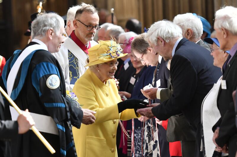 Queen Elizabeth II distributes the Maundy money during the Royal Maundy Service at St George's Chapel in Windsor in 2019. PA