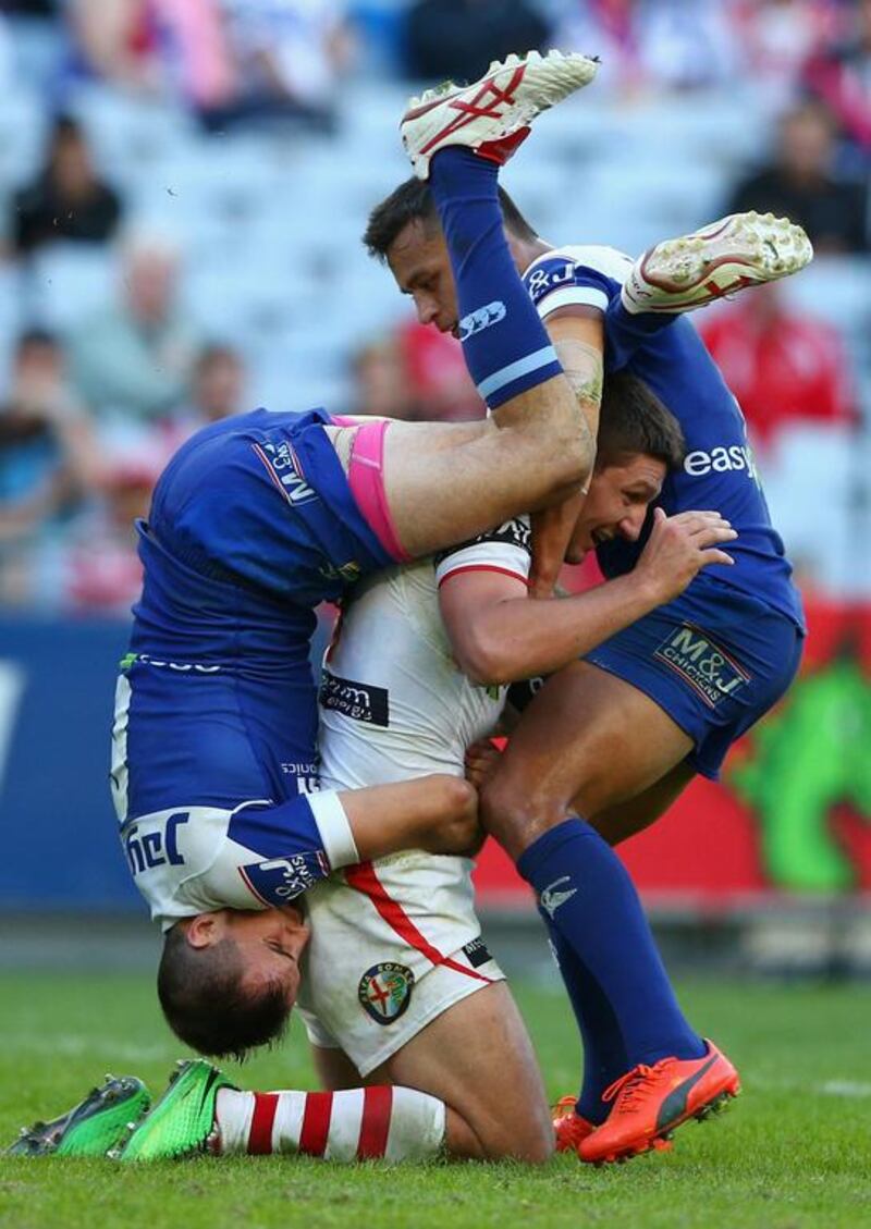 Gareth Widdop of the Dragons is tacked by Josh Reynolds of the Bulldogs (L) and Sam Perrett of the Bulldogs during the round nine NRL match between the St George Illawarra Dragons and the Canterbury-Bankstown Bulldogs at ANZ Stadium in Sydney, Australia. Cameron Spencer / Getty