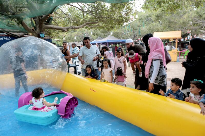 epa06962794 Children play at the popular amusement park 'Horsh Beirut' to celebrate Eid Al-Adha in Beirut, Lebanon, 21 August 2018. Eid al-Adha is the holiest of the two Muslims holidays celebrated each year, it marks the yearly Muslim pilgrimage (Hajj) to visit Mecca, the holiest place in Islam. Muslims slaughter a sacrificial animal and split the meat into three parts, one for the family, one for friends and relatives, and one for the poor and needy.  EPA-EFE/NABIL MOUNZER *** Local Caption *** 54566965