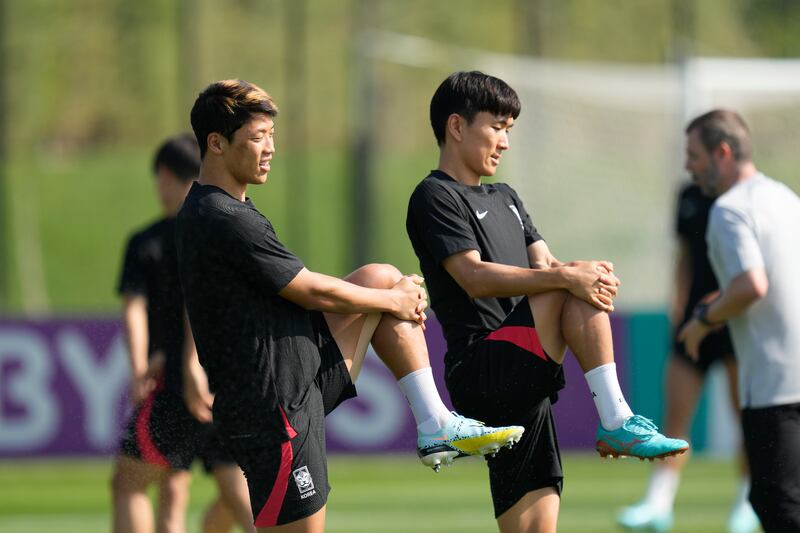 South Korea's Hwang Hee-chan, left, and Hwang In-beom warm up on Sunday. AP