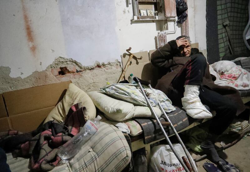 People gather in the basement of a local hospital, which was damaged during clashes in Volnovakha. Reuters