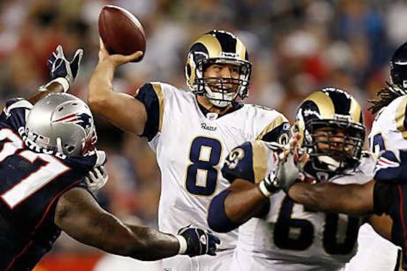 Sam Bradford, the St Louis quarterback who was the top selection in this year's draft, throws under pressure from New England's Ron Brace, left, during the Rams' exhibition victory on Thursday night.