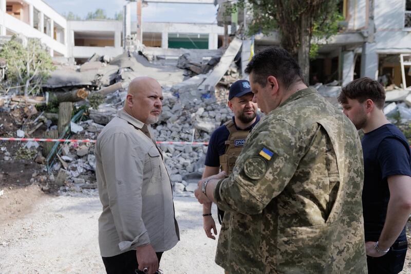 Karim Khan, International Criminal Court prosecutor, left, visits the site of an alleged Russian war crime in Kharkiv, Ukraine. AFP