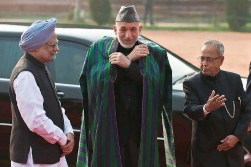 Afghanistan president Hamid Karzai (centre) talks with Indian president Pranab Mukherjee (right) and Indian prime minister Manmohan Singh during a reception in New Delhi yesterday.