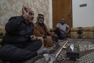 Alaa Al Rikabi, left, speaks to voters in the southern city of Nasiriyah to explain his motives for standing in the Iraqi general election on October 10 and the importance of casting their ballot. Haider Husseini / The National                                