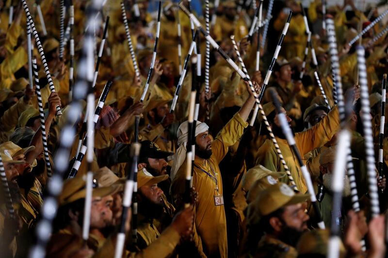 Supporters wave sticks as they listen to the speech of their leaders. Reuters