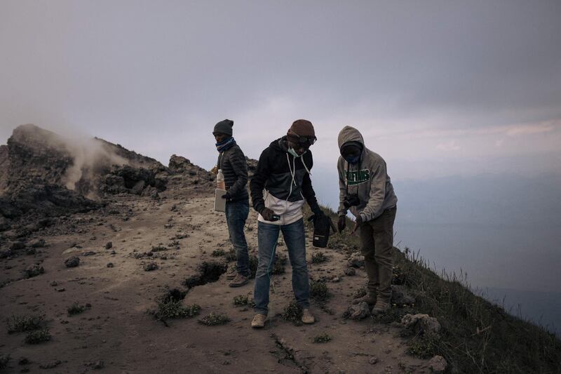 Congolese volcanologists take temperature readings atop Nyiragongo volcano.
.