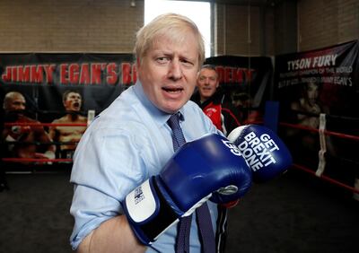 Britain's Prime Minister Boris Johnson dons some boxing gloves for a 'sparring session' during a stop in his General Election Campaign trail at Jimmy Egan's Boxing Academy in Manchester, Britain November 19, 2019. Frank Augstein/Pool via REUTERS